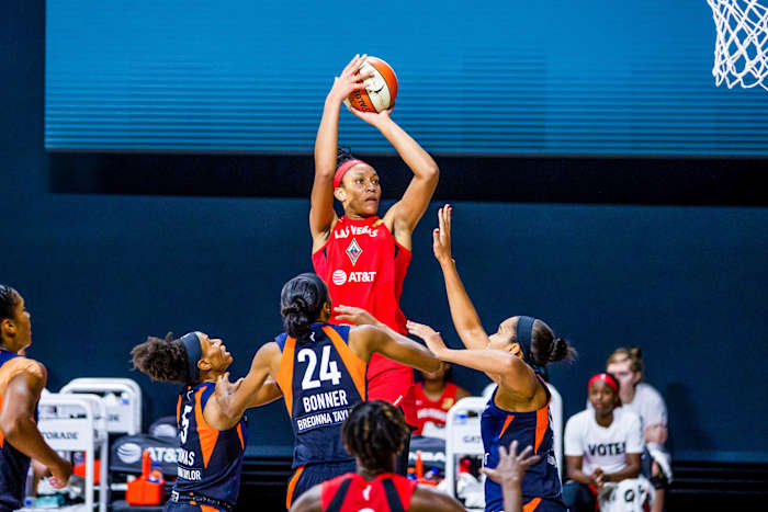 A'ja Wilson shoots over a group of Connecticut defenders